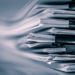 a stack of clipped papers